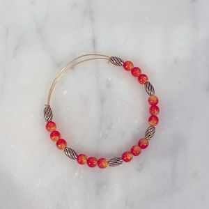 Alex and Ani iredescent orange bangle bracelet.